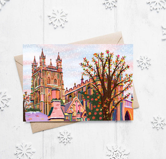Colorful greeting card with a cathedral design on a white background with snowflake decorations