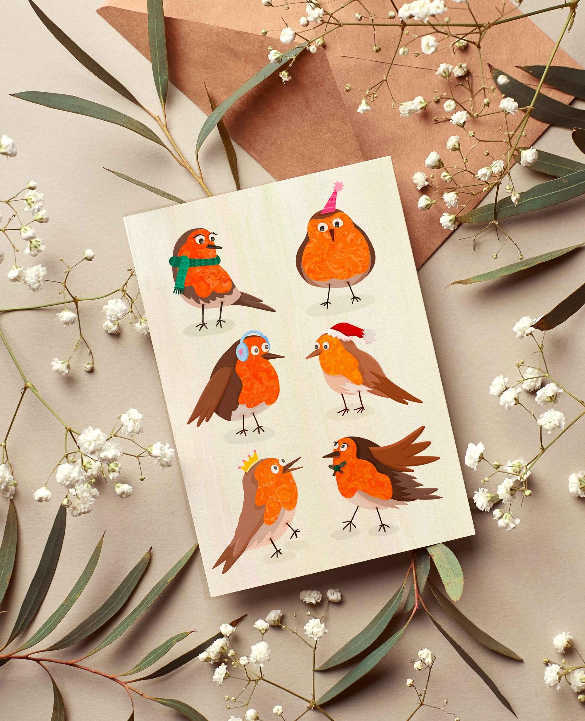 Greeting card with illustrated robins on a beige background with leaves and flowers.